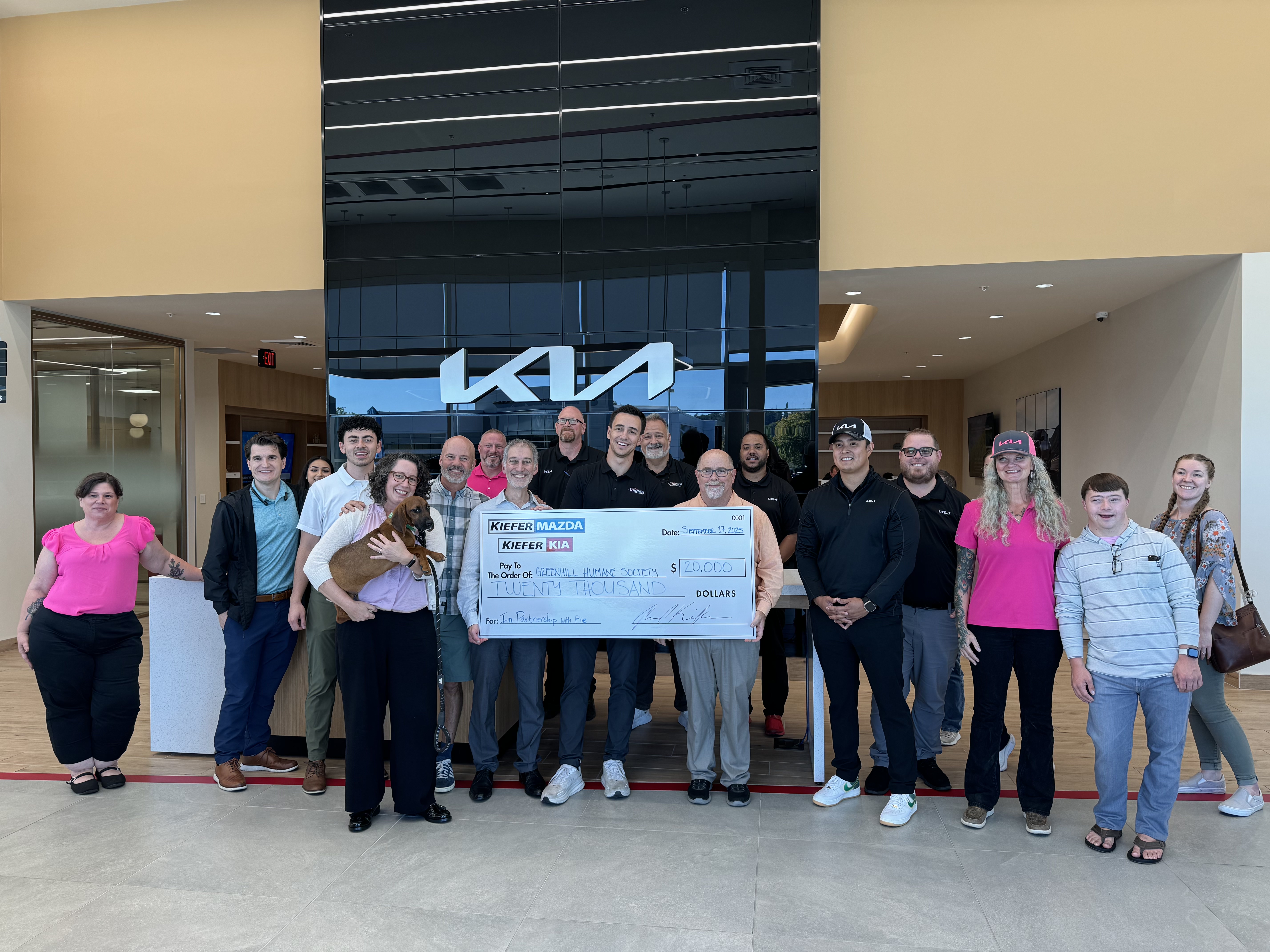 Kiefer Auto Group presenting a donation check to Greenhill Humane Society at the Kia dealership