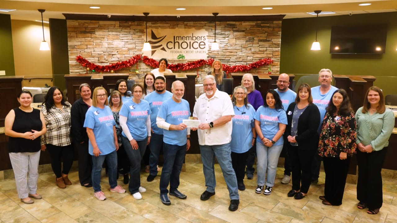 Members Choice representatives and CCA supporters at a check presentation