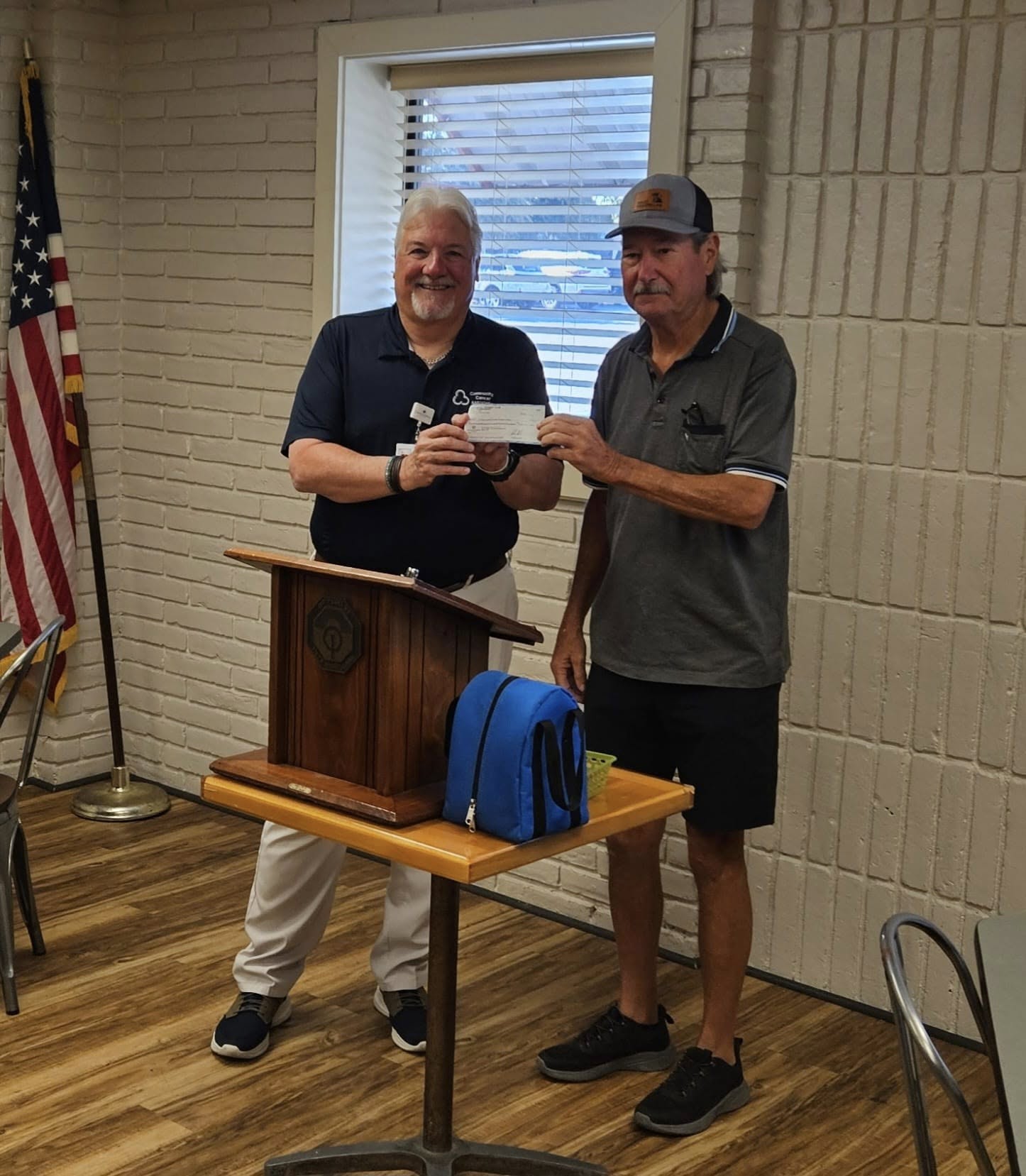 Northwest Waco Optimist Club representative presenting a check to CCA