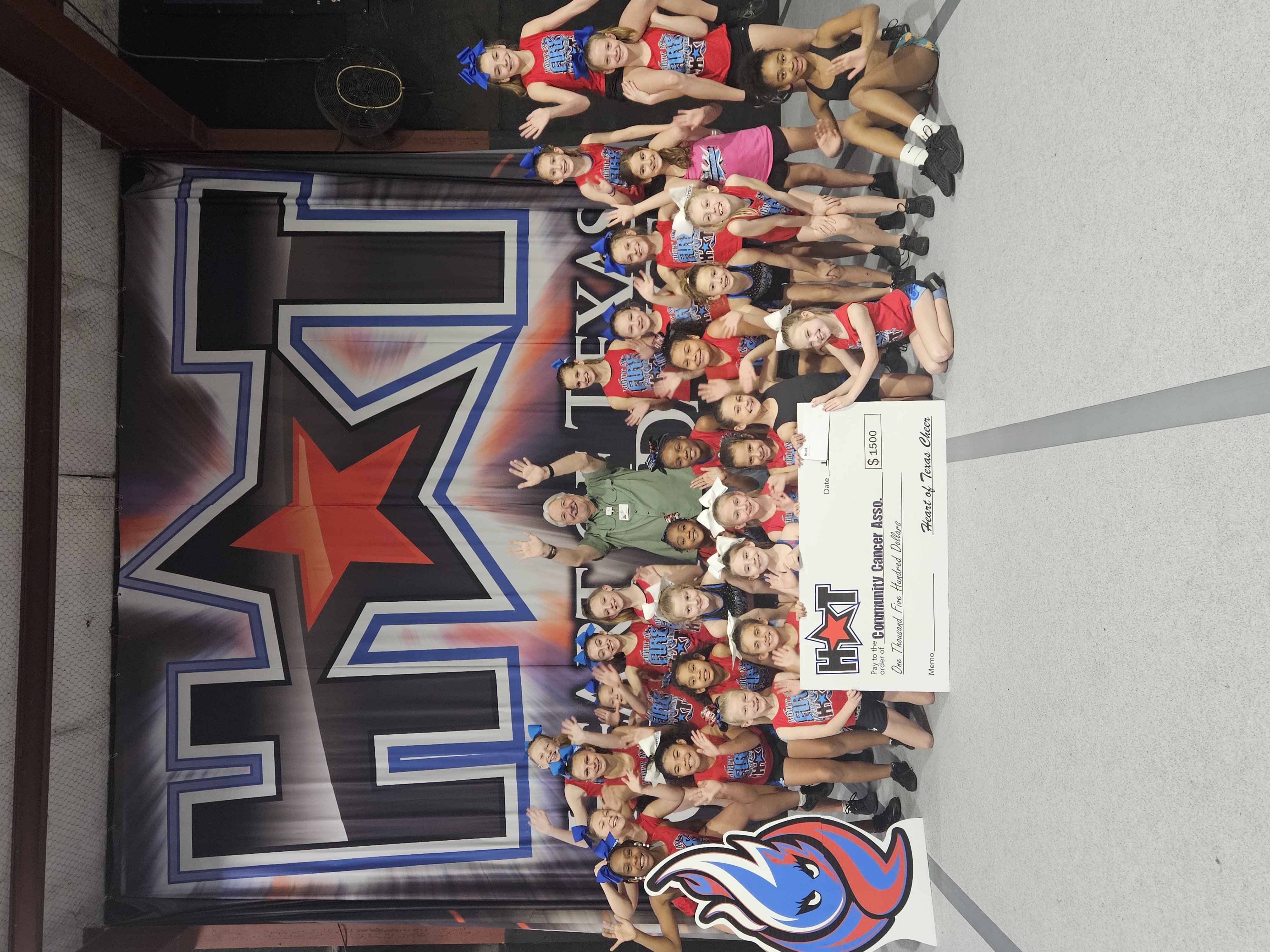 Heart of Texas cheer team gathered for a donation presentation to CCA