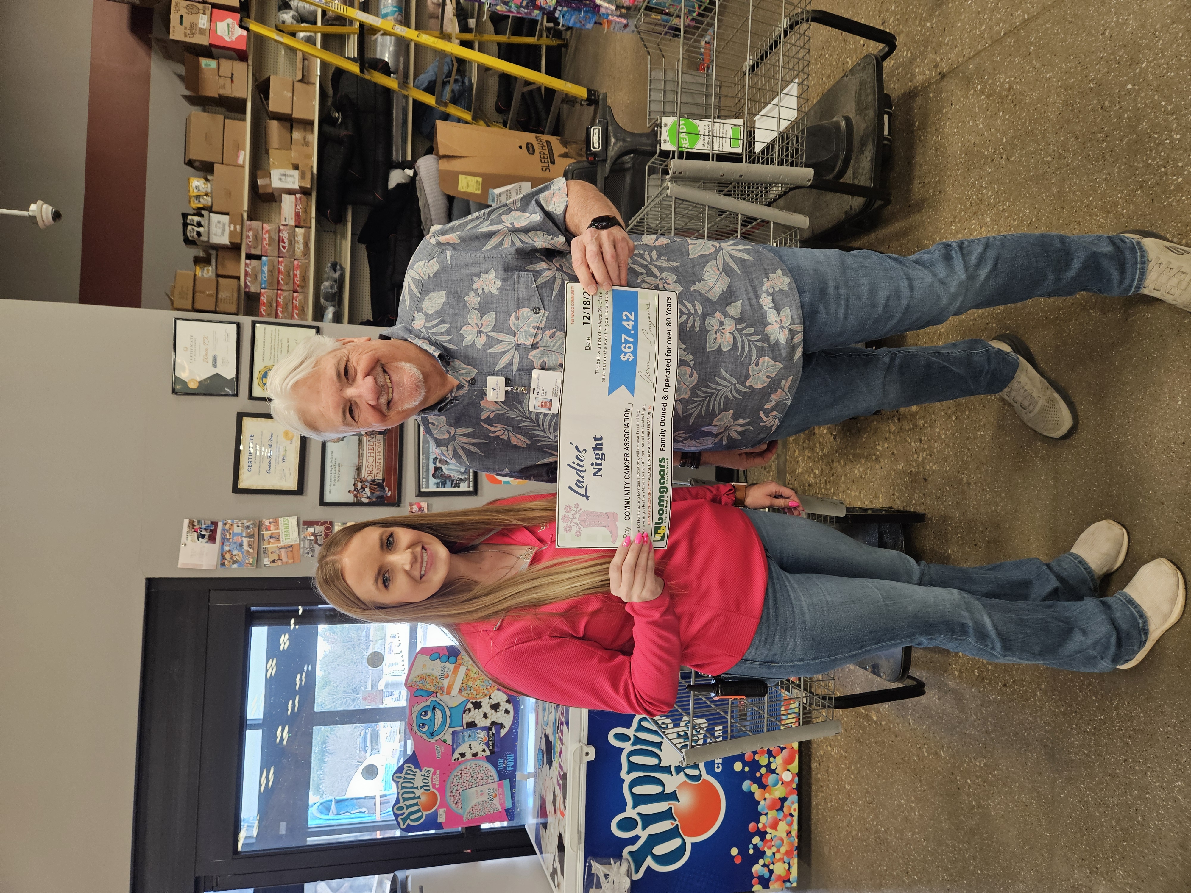 A supporter presenting a donation check to CCA