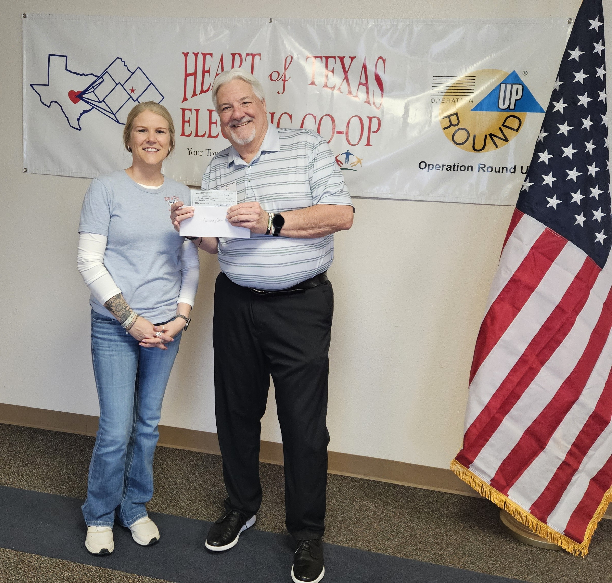 Heart of Texas Electric Cooperative representative presenting a donation check to CCA