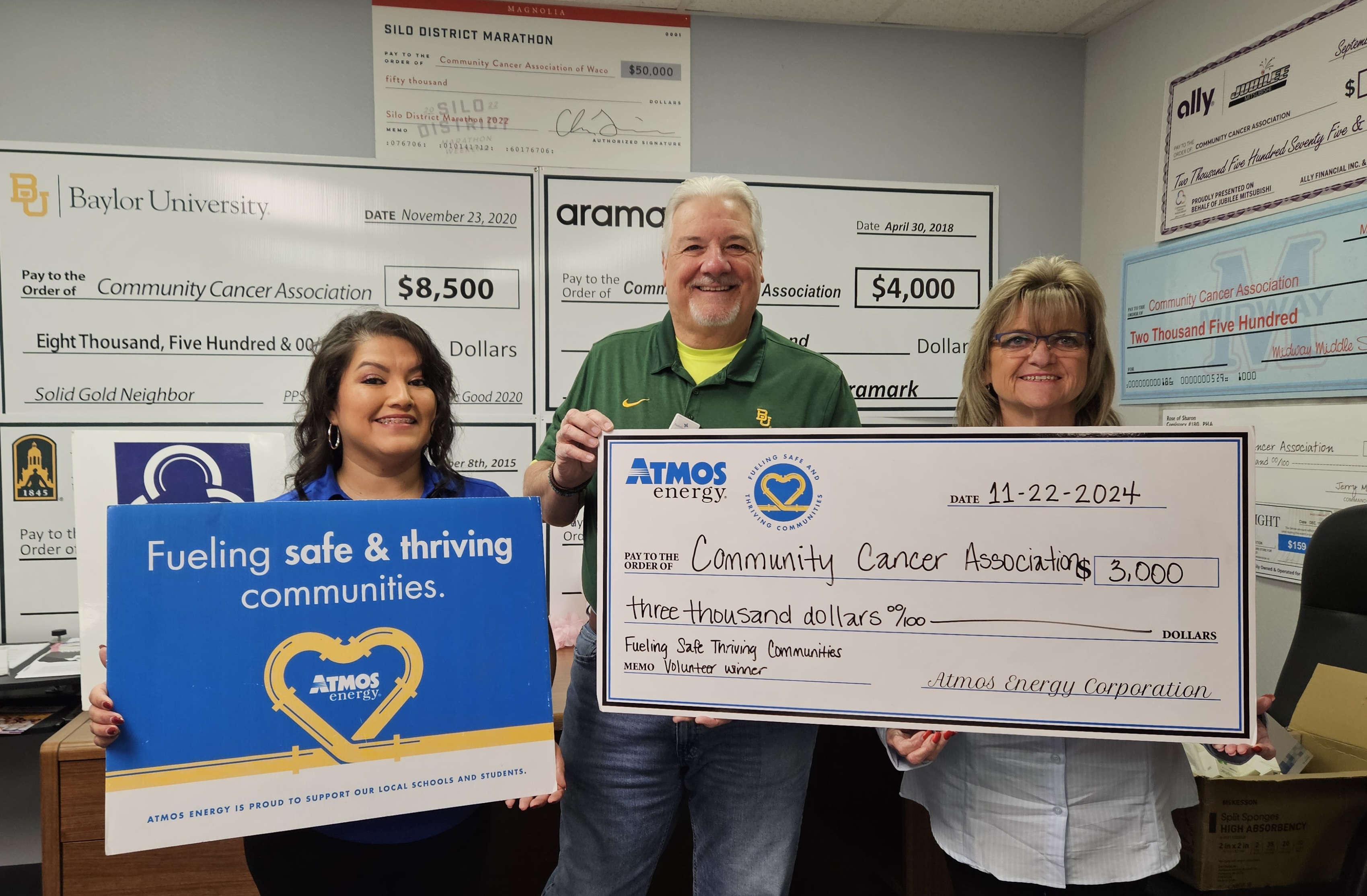Atmos Energy representatives presenting a donation check to CCA