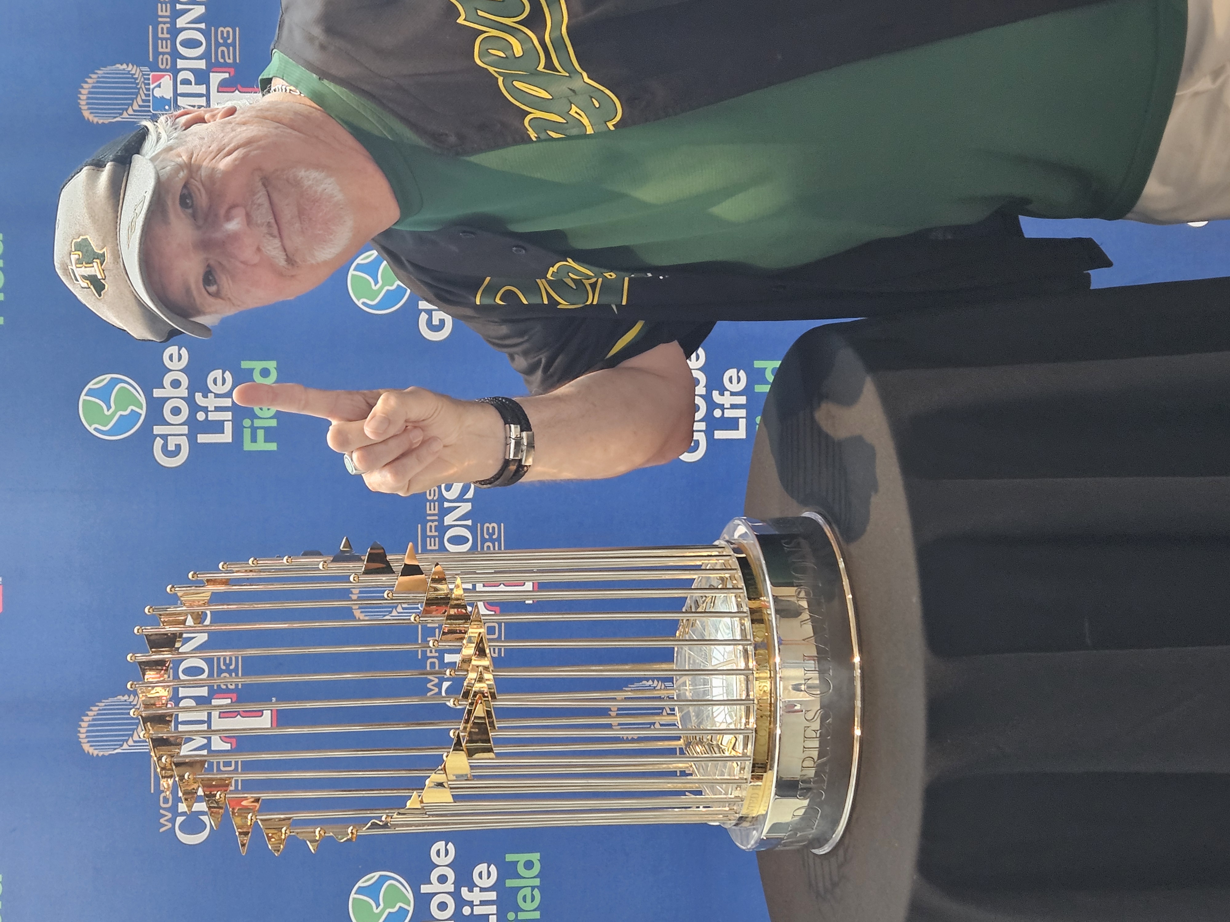 Terry Hunt beside the World Series trophy at Globe Life Field